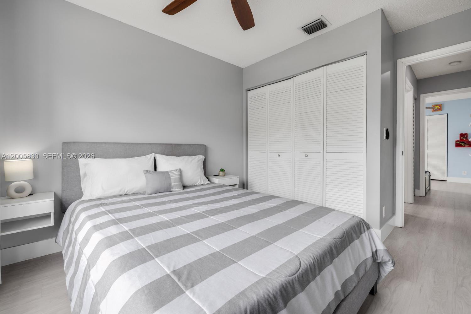 5861 South Sable Circle Margate, FL 33063 - Photo 22 of 56 a bedroom with a bed and a chandelier