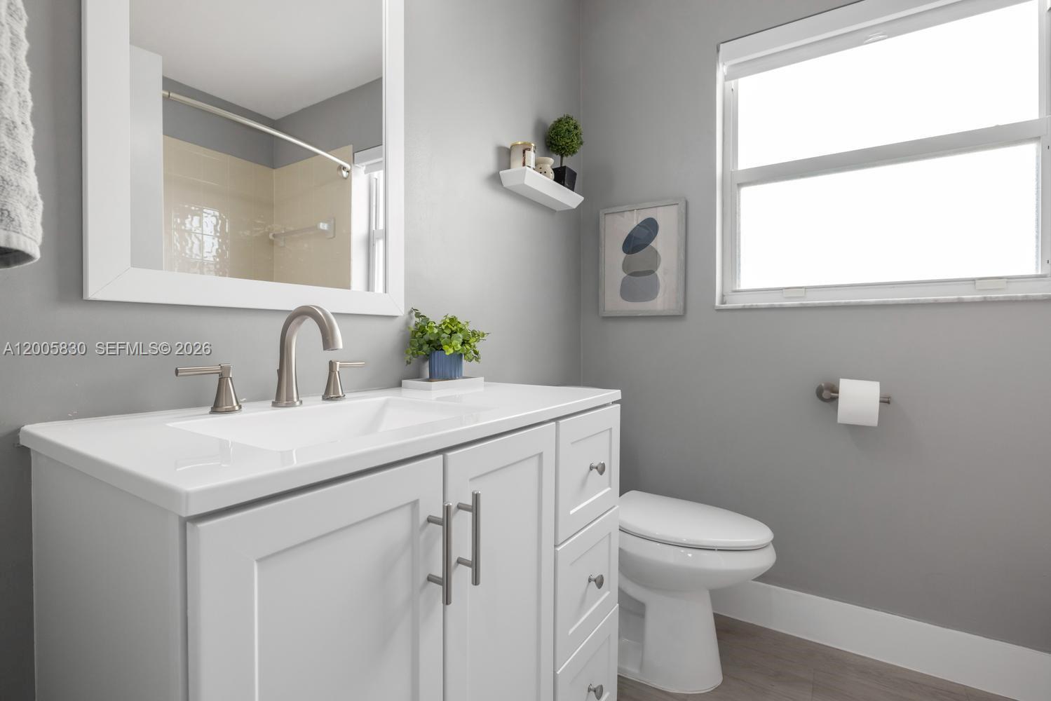 5861 South Sable Circle Margate, FL 33063 - Photo 23 of 56 a bathroom with a toilet sink and mirror