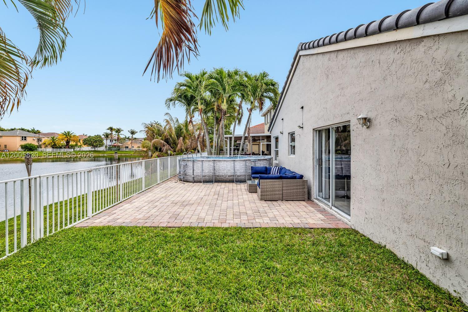 5861 South Sable Circle Margate, FL 33063 - Photo 28 of 56 a view of a backyard with plants and palm tree