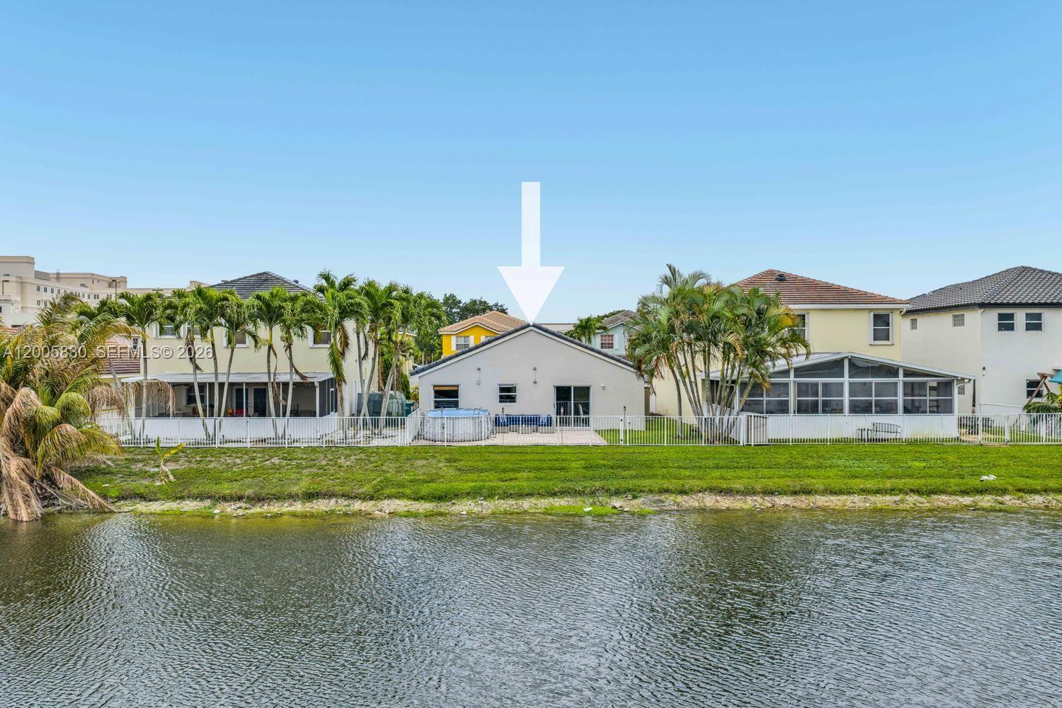 5861 South Sable Circle Margate, FL 33063 - Photo 38 of 56 a front view of a house with a garden and yard