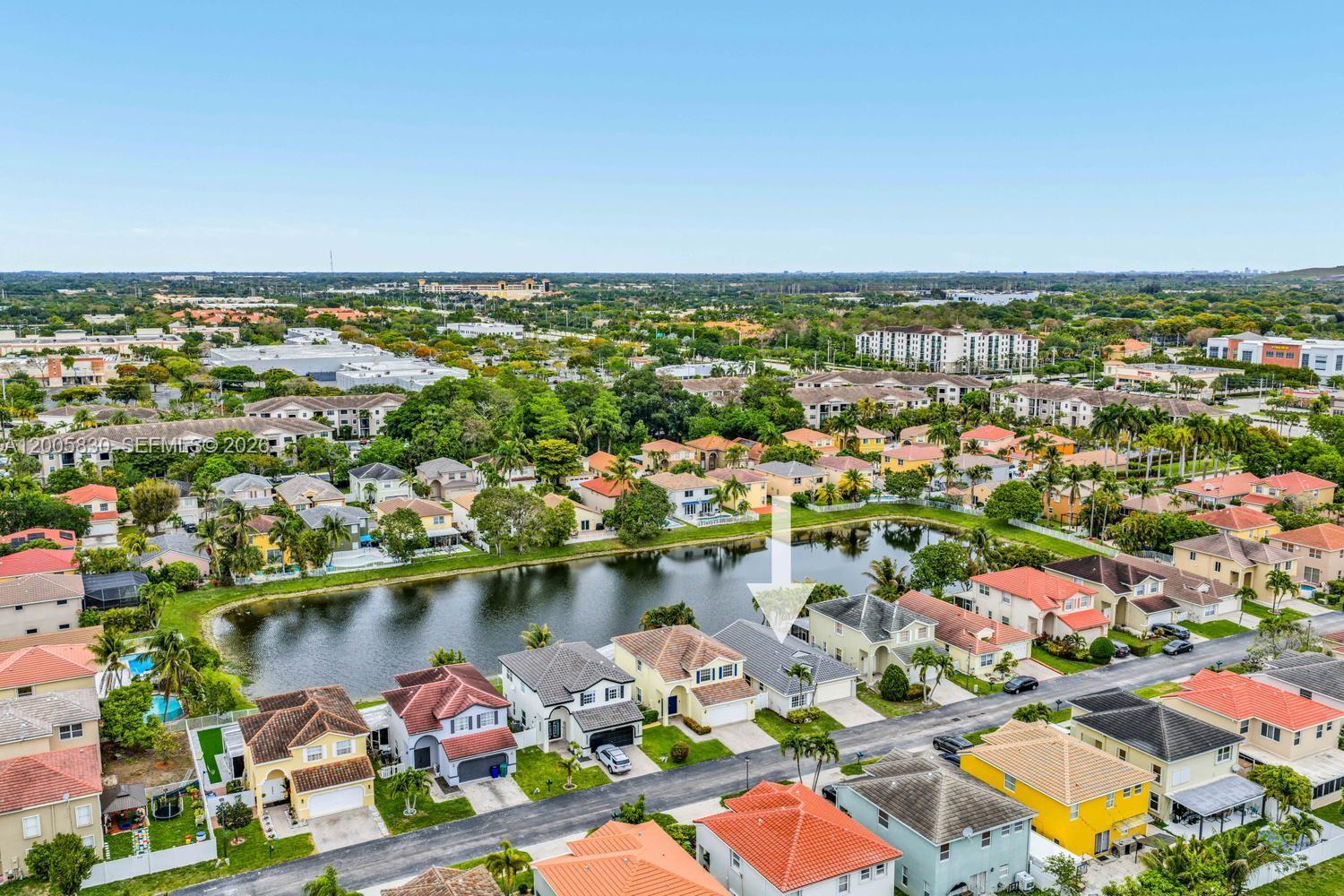 5861 South Sable Circle Margate, FL 33063 - Photo 46 of 56 an aerial view of a city with lots of residential buildings and ocean view in back