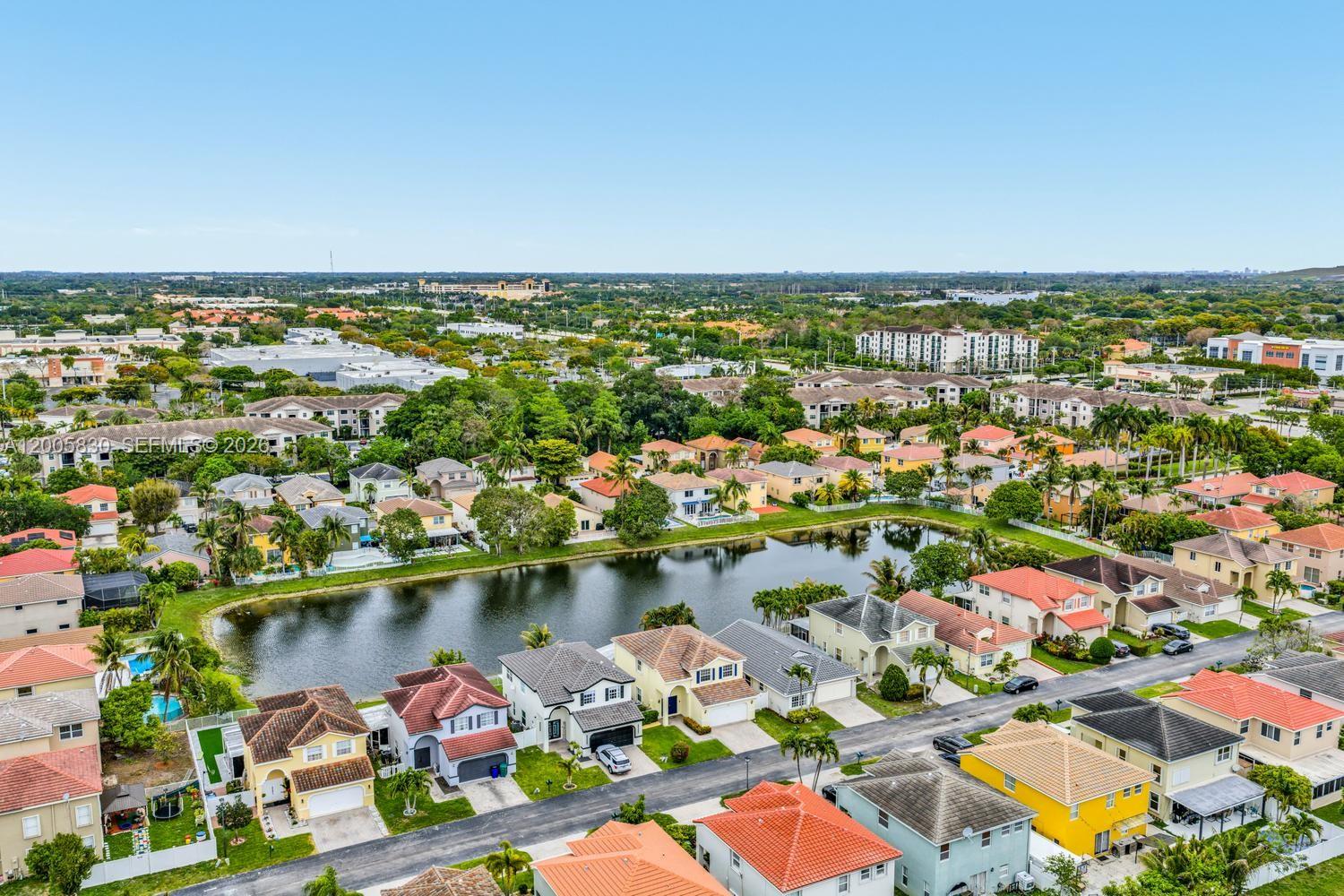 5861 South Sable Circle Margate, FL 33063 - Photo 47 of 56 an aerial view of a city with lots of residential buildings and ocean view in back