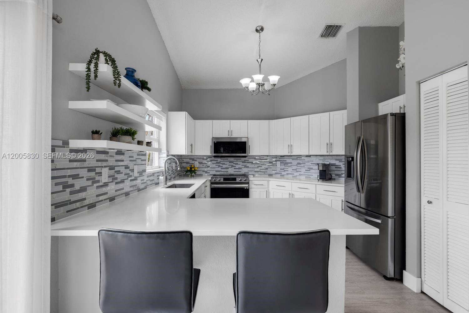 5861 South Sable Circle Margate, FL 33063 - Photo 9 of 56 a kitchen with a sink stainless steel appliances and cabinets