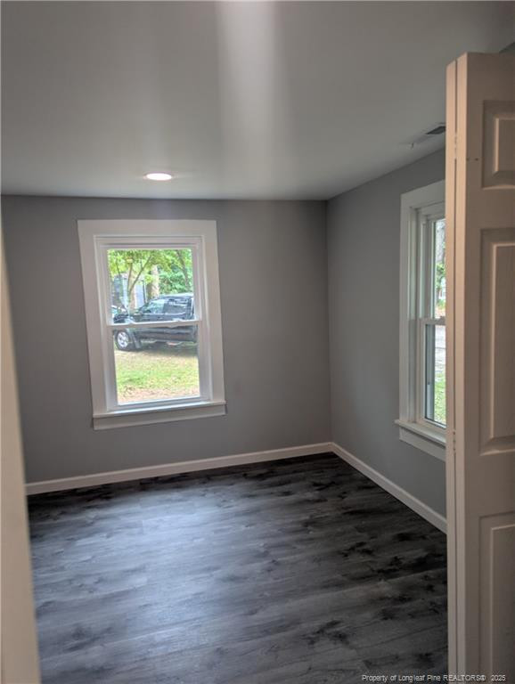 245 Maxie Loop Spring Lake, NC 28390 - Photo 4 of 10 an empty room with wooden floor and windows