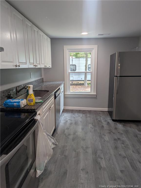245 Maxie Loop Spring Lake, NC 28390 - Photo 5 of 10 a kitchen with a sink stove and cabinets