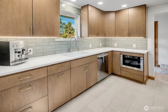 a kitchen with stainless steel appliances granite countertop a sink and cabinets