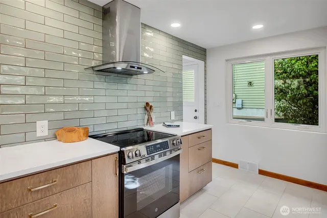 a kitchen with stainless steel appliances granite countertop a sink and a wooden cabinets