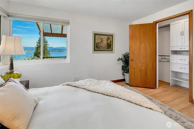 a bedroom with a bed and a lamp on table