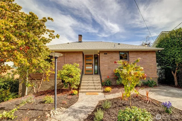 a front view of a house with garden