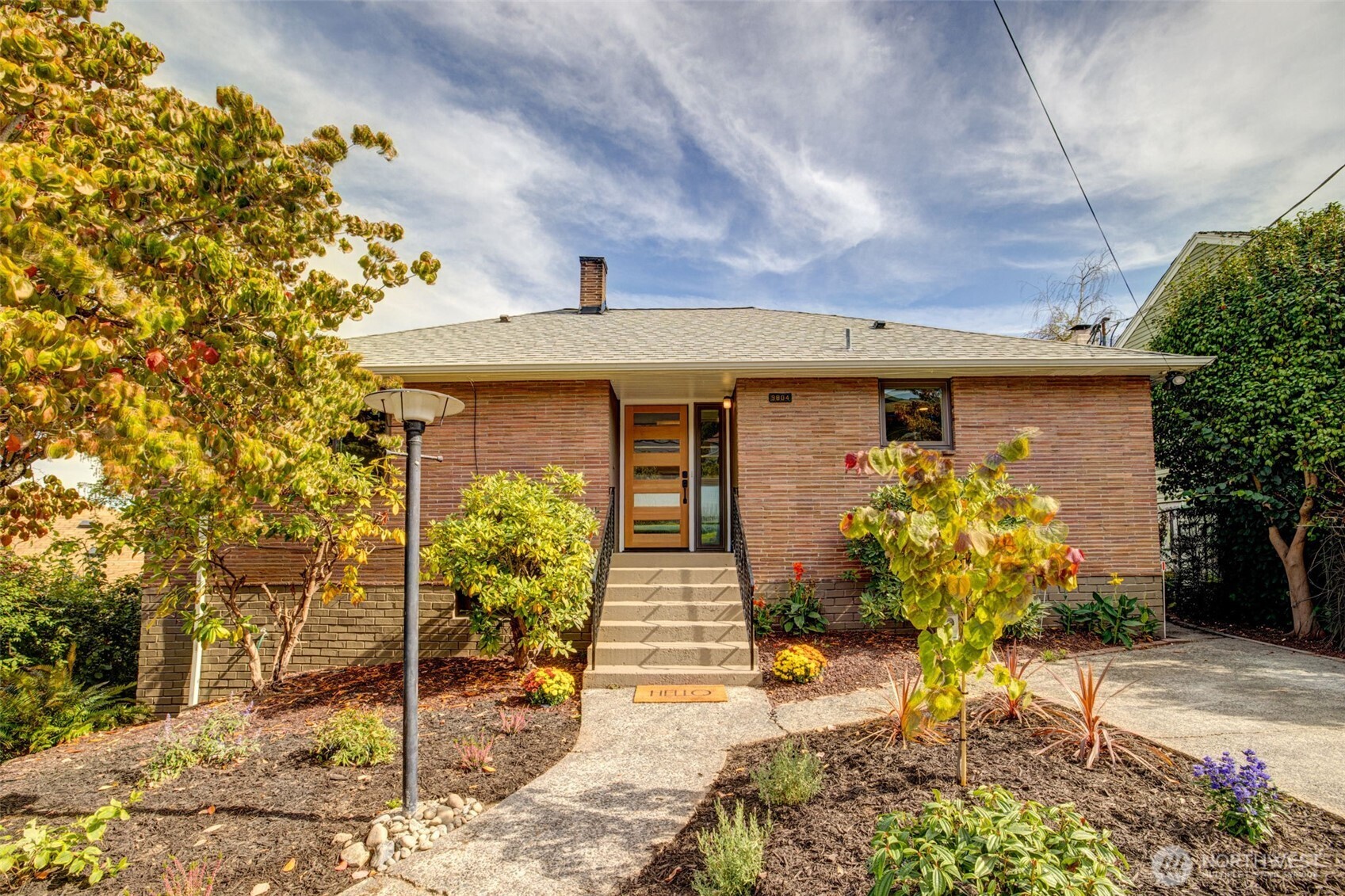 9804 63rd Avenue South Seattle, WA 98118 - Photo 3 of 40 a front view of a house with garden