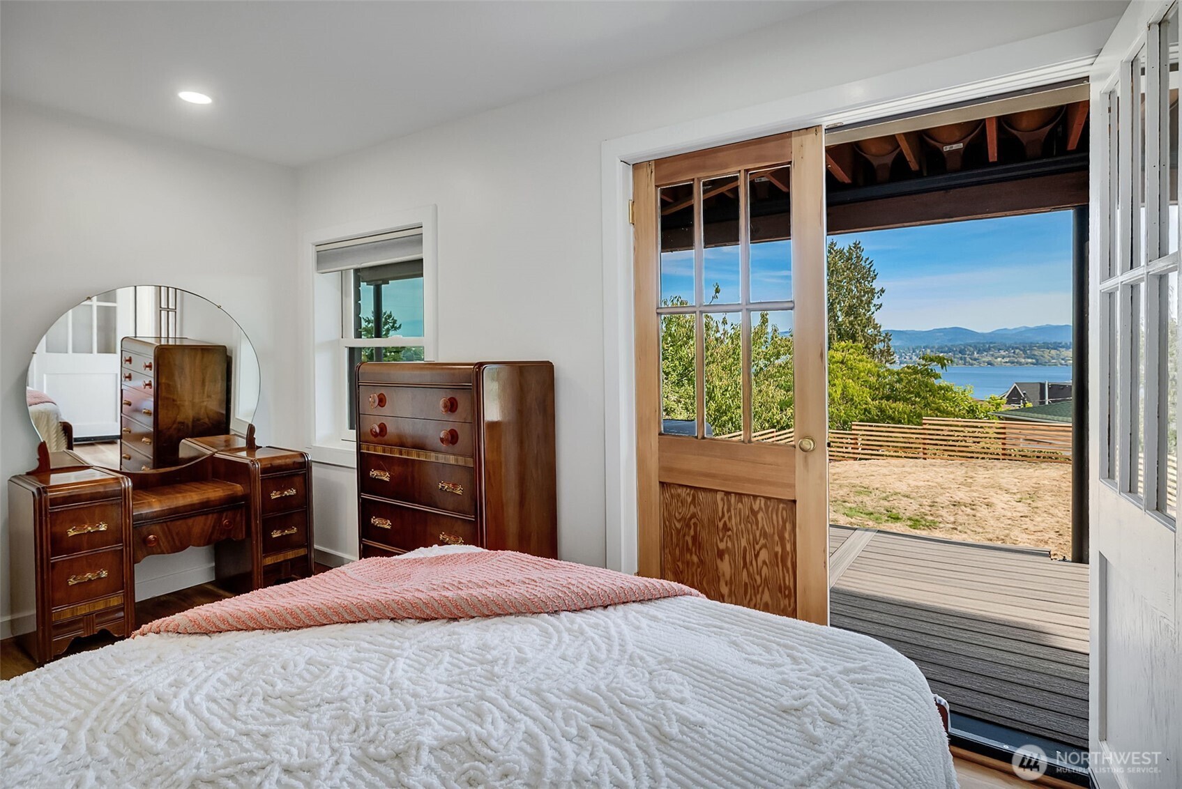 9804 63rd Avenue South Seattle, WA 98118 - Photo 31 of 40 a bedroom with a bed and a flat tv screen on dresser