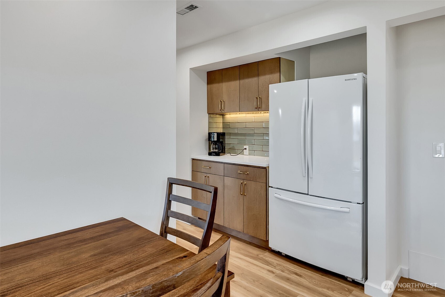 9804 63rd Avenue South Seattle, WA 98118 - Photo 33 of 40 a kitchen with a refrigerator and a stove top oven