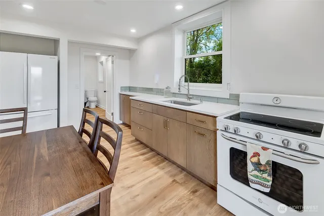 a kitchen with a stove a sink and a refrigerator