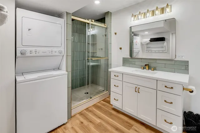 a bathroom with a shower sink and mirror