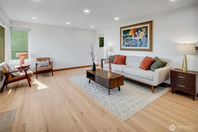 a living room with furniture and a wooden floor