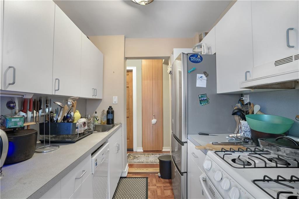 1075 Sheepshead Bay Road, Unit 2S Brooklyn, NY 11229 - Photo 11 of 30 a kitchen with stainless steel appliances granite countertop a stove and a wooden cabinets