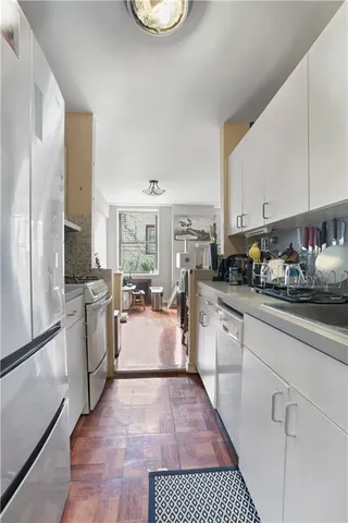 a kitchen with sink refrigerator and stove