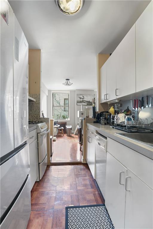 1075 Sheepshead Bay Road, Unit 2S Brooklyn, NY 11229 - Photo 13 of 30 a kitchen with sink refrigerator and stove