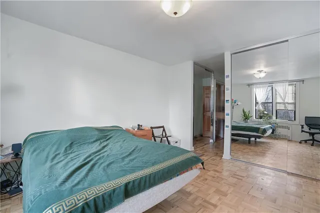 a bedroom with a bed and a mirror