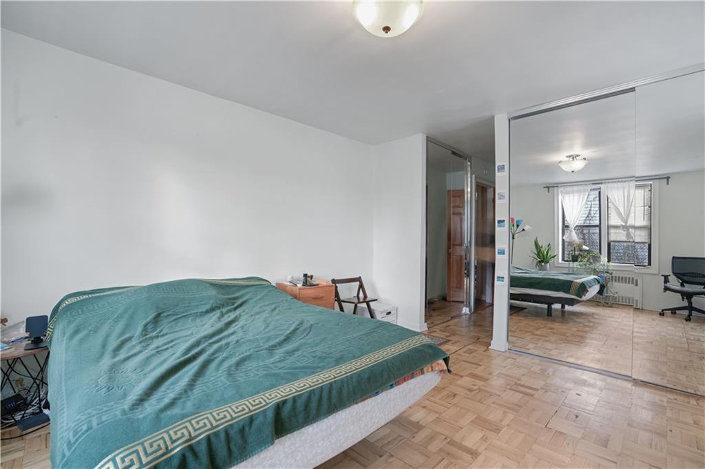 1075 Sheepshead Bay Road, Unit 2S Brooklyn, NY 11229 - Photo 15 of 30 a bedroom with a bed and a mirror