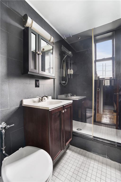 1075 Sheepshead Bay Road, Unit 2S Brooklyn, NY 11229 - Photo 20 of 30 a bathroom with a sink a toilet a mirror and vanity