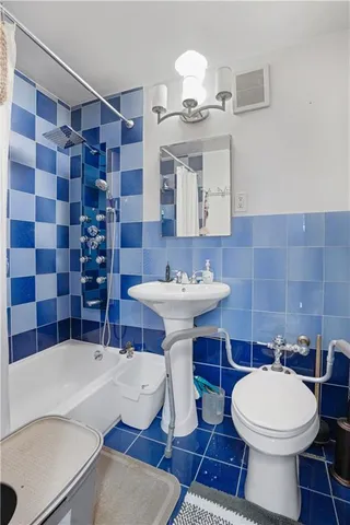 a bathroom with a sink a toilet and mirror