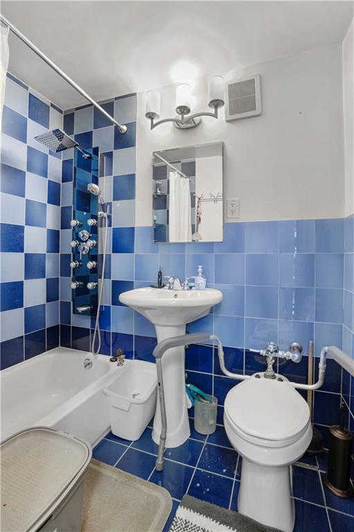 1075 Sheepshead Bay Road, Unit 2S Brooklyn, NY 11229 - Photo 22 of 30 a bathroom with a sink a toilet and shower