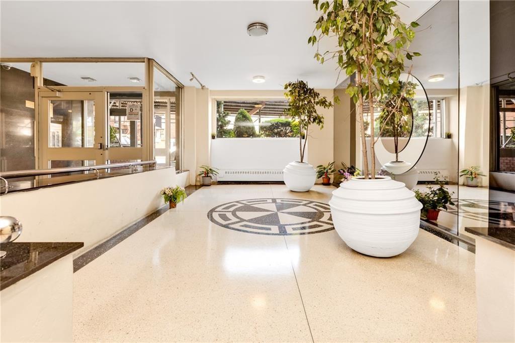 1075 Sheepshead Bay Road, Unit 2S Brooklyn, NY 11229 - Photo 4 of 30 a living room with furniture and a large window