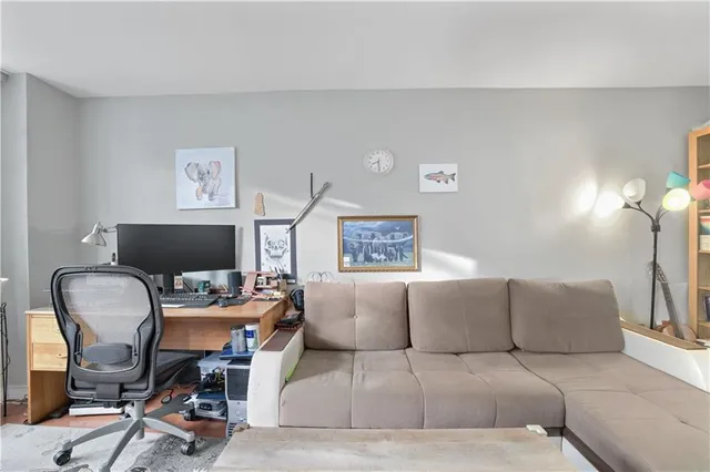 a living room with furniture and a chair
