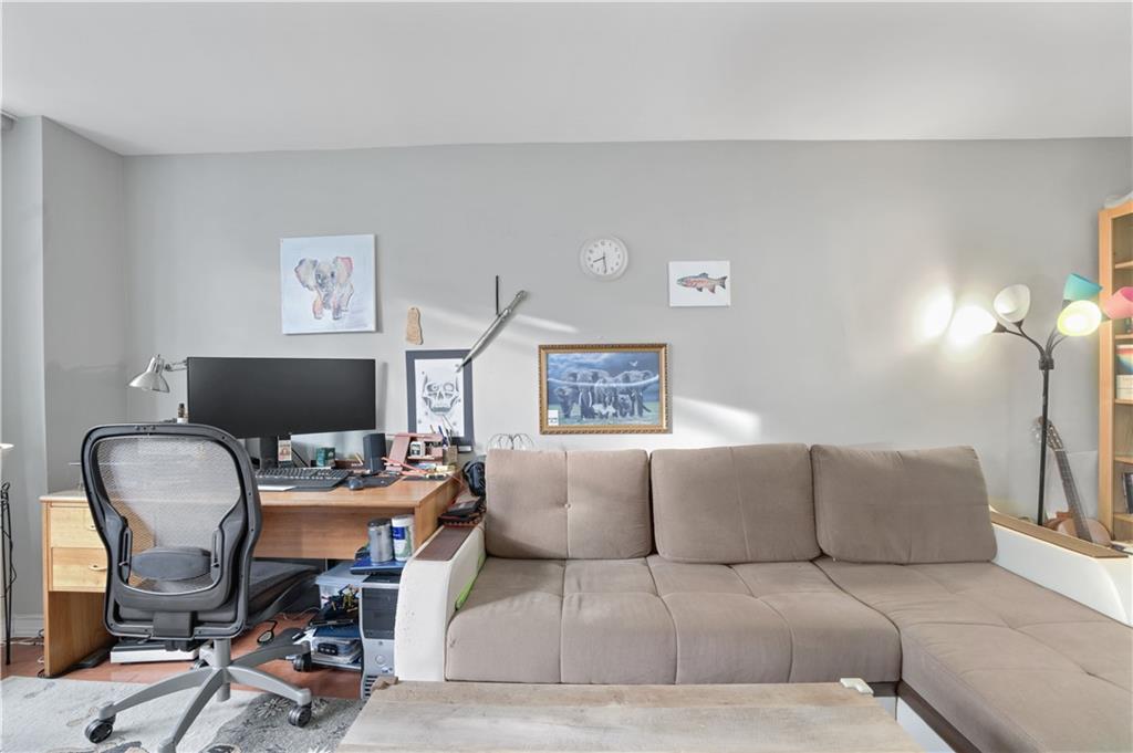 1075 Sheepshead Bay Road, Unit 2S Brooklyn, NY 11229 - Photo 6 of 30 a living room with furniture and a chair