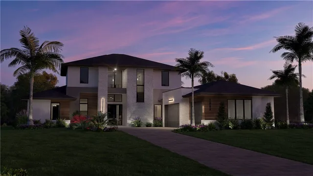 a front view of a house with a garden and yard