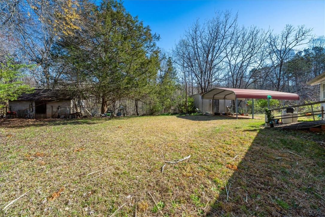 453 Deaton Road Walhalla, SC 29691 - Photo 13 of 28 This spacious yard offers ample green space and a convenient carport for outdoor living.