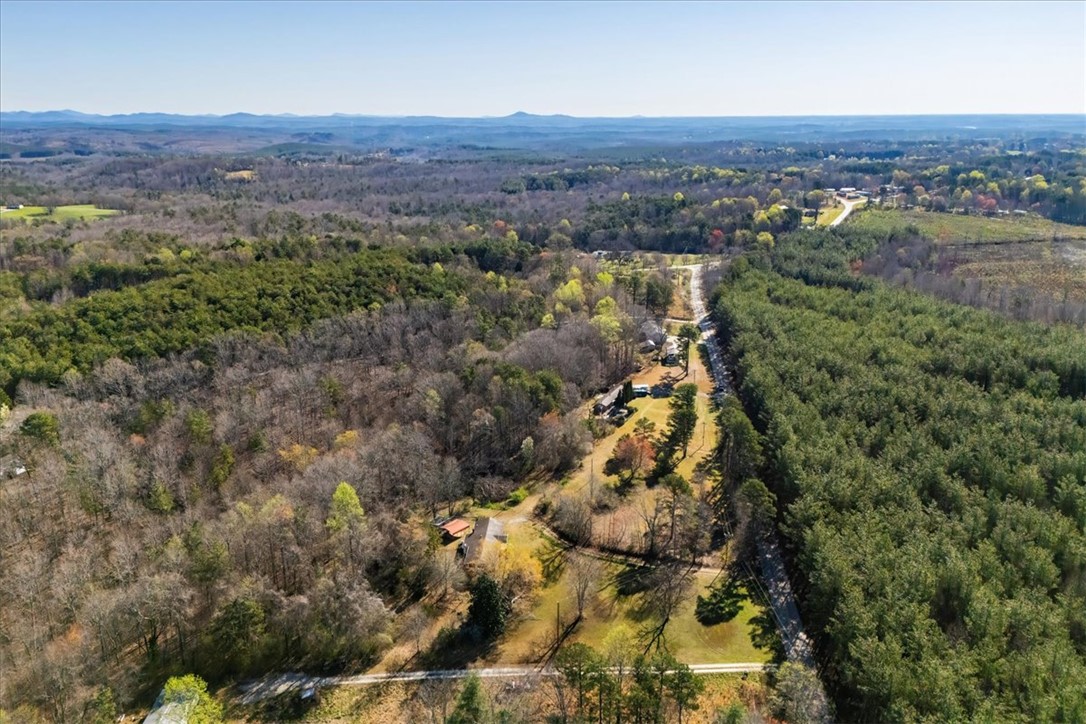 453 Deaton Road Walhalla, SC 29691 - Photo 17 of 28 This elevated view captures a serene landscape with dense woodlands and distant mountains.