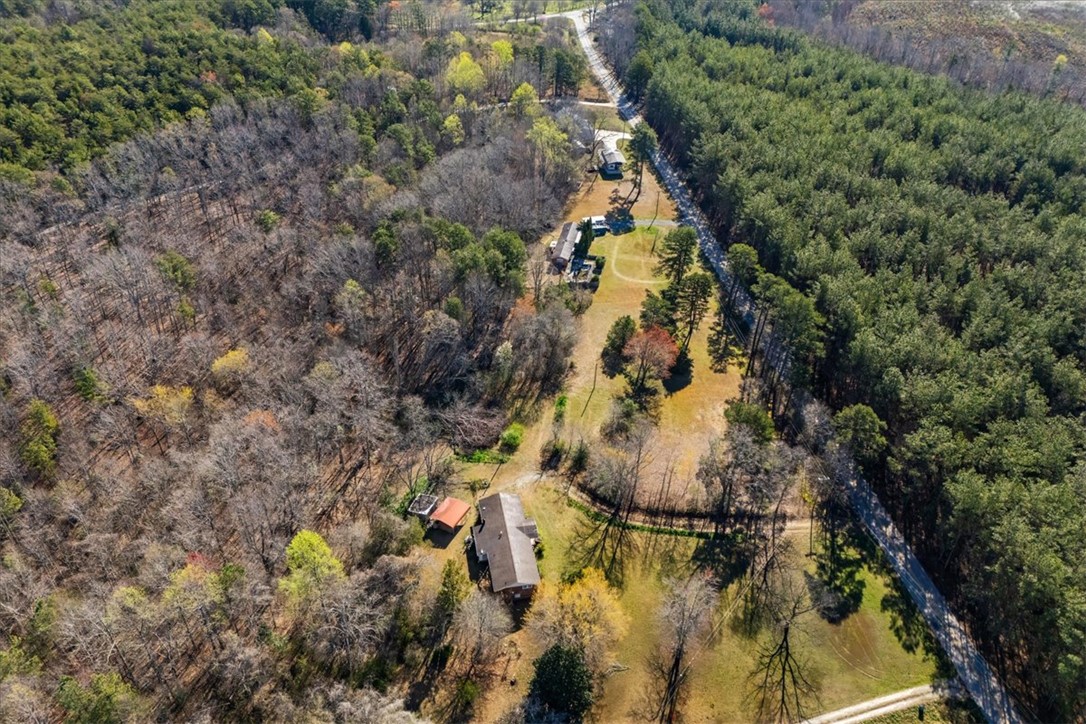 453 Deaton Road Walhalla, SC 29691 - Photo 2 of 28 An aerial view captures the vast, tree-lined landscape surrounding a tranquil residence.