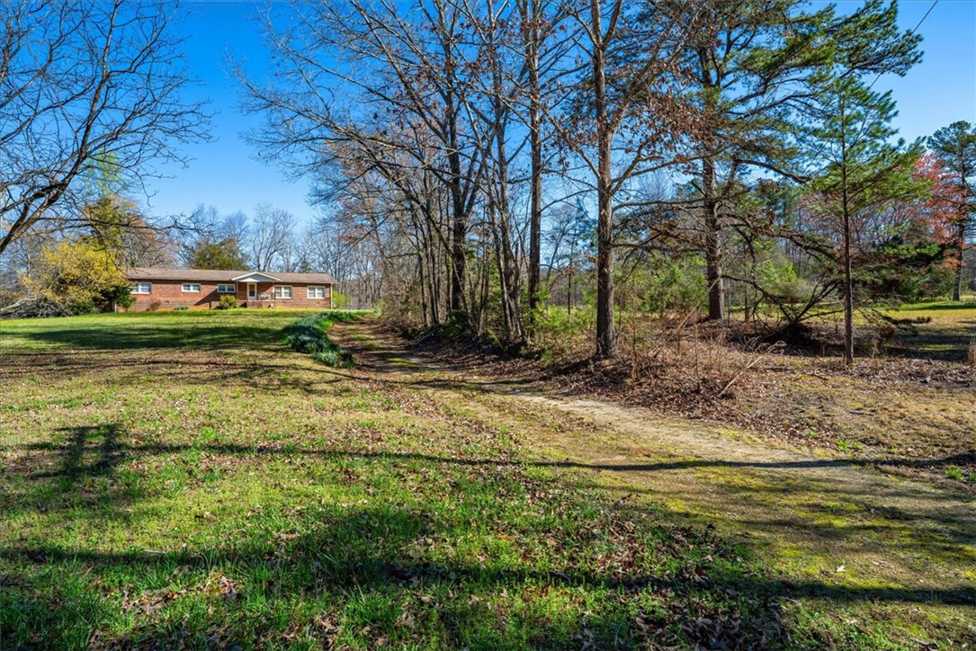 453 Deaton Road Walhalla, SC 29691 - Photo 9 of 28 This charming residence offers a peaceful retreat nestled amidst mature trees and lush greenery.
