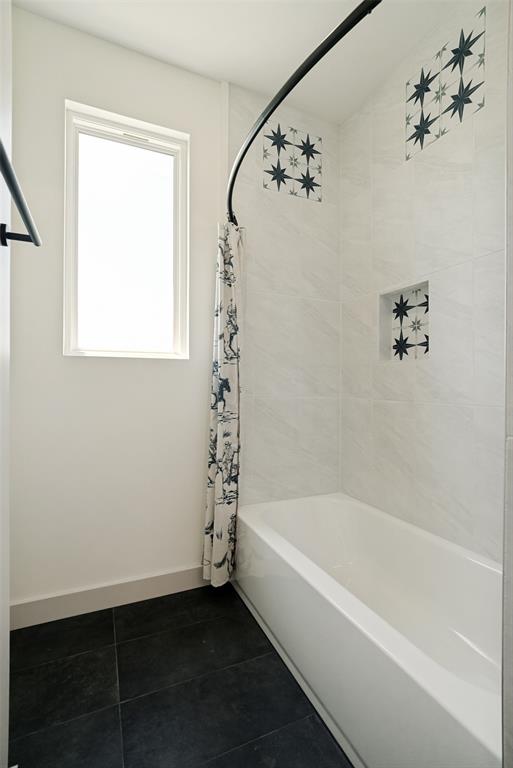 1150 Doss Road Millsap, TX 76066 - Photo 30 of 32 Bathtub and shower combination featuring white subway tile, stunning decorative accent tiles, a shower niche, and a black curved shower rod
