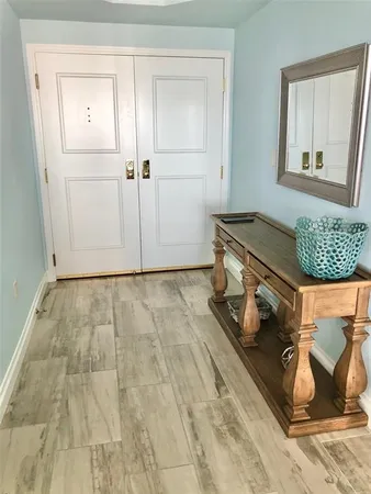 an empty room with wooden floor and a window
