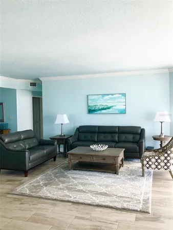 a living room with furniture and a lamp