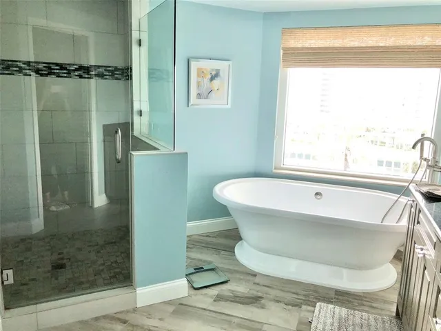 a bathroom with a bathtub and a shower