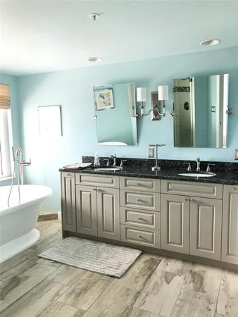 a spacious bathroom with a sink and a mirror