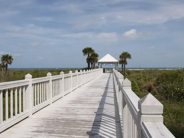 a view of a balcony with wooden floor and seating space