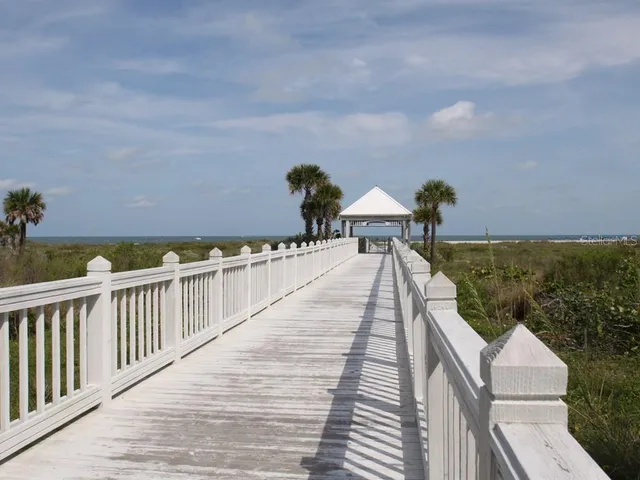 a view of a balcony with wooden floor and seating space