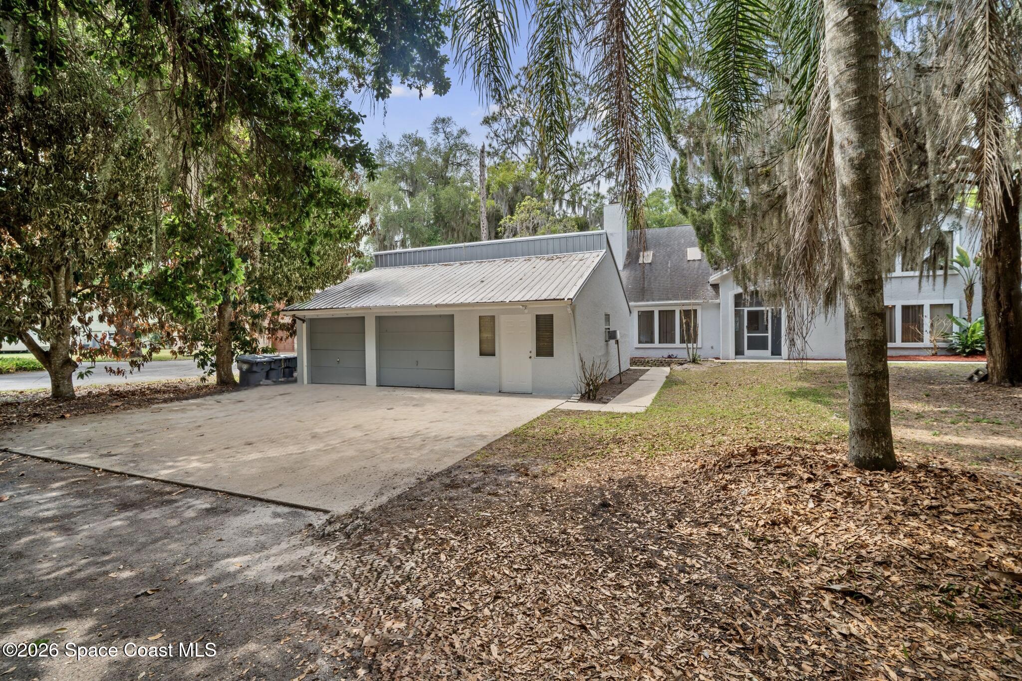 130 North Carpenter Road Titusville, FL 32796 - Photo 2 of 30 a front view of a house with a garden