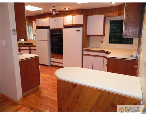 440 Old Post Road Edison, NJ 08817 - Photo 14 of 17 a kitchen with stainless steel appliances a stove refrigerator sink and cabinets