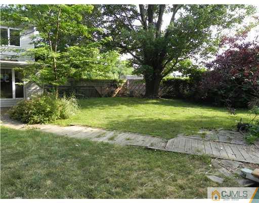 440 Old Post Road Edison, NJ 08817 - Photo 16 of 17 a backyard of a house with plants and large trees