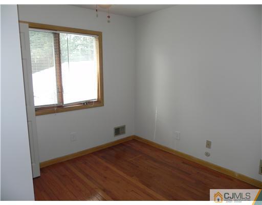 440 Old Post Road Edison, NJ 08817 - Photo 10 of 17 an empty room with wooden floor and windows
