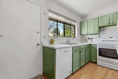 a kitchen with sink a window and appliances