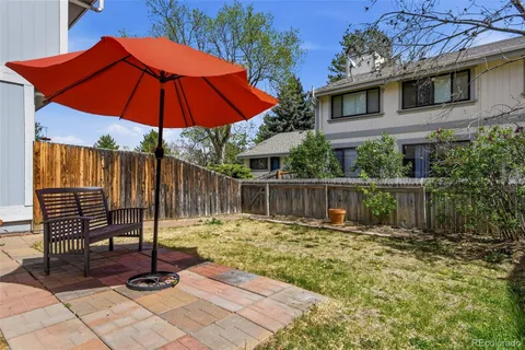 a view of a chair and tables in the backyard