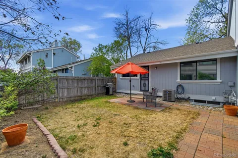 a view of a house with backyard and sitting area