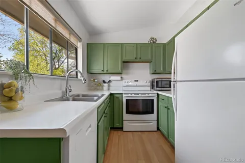 a kitchen with a sink a stove and a refrigerator